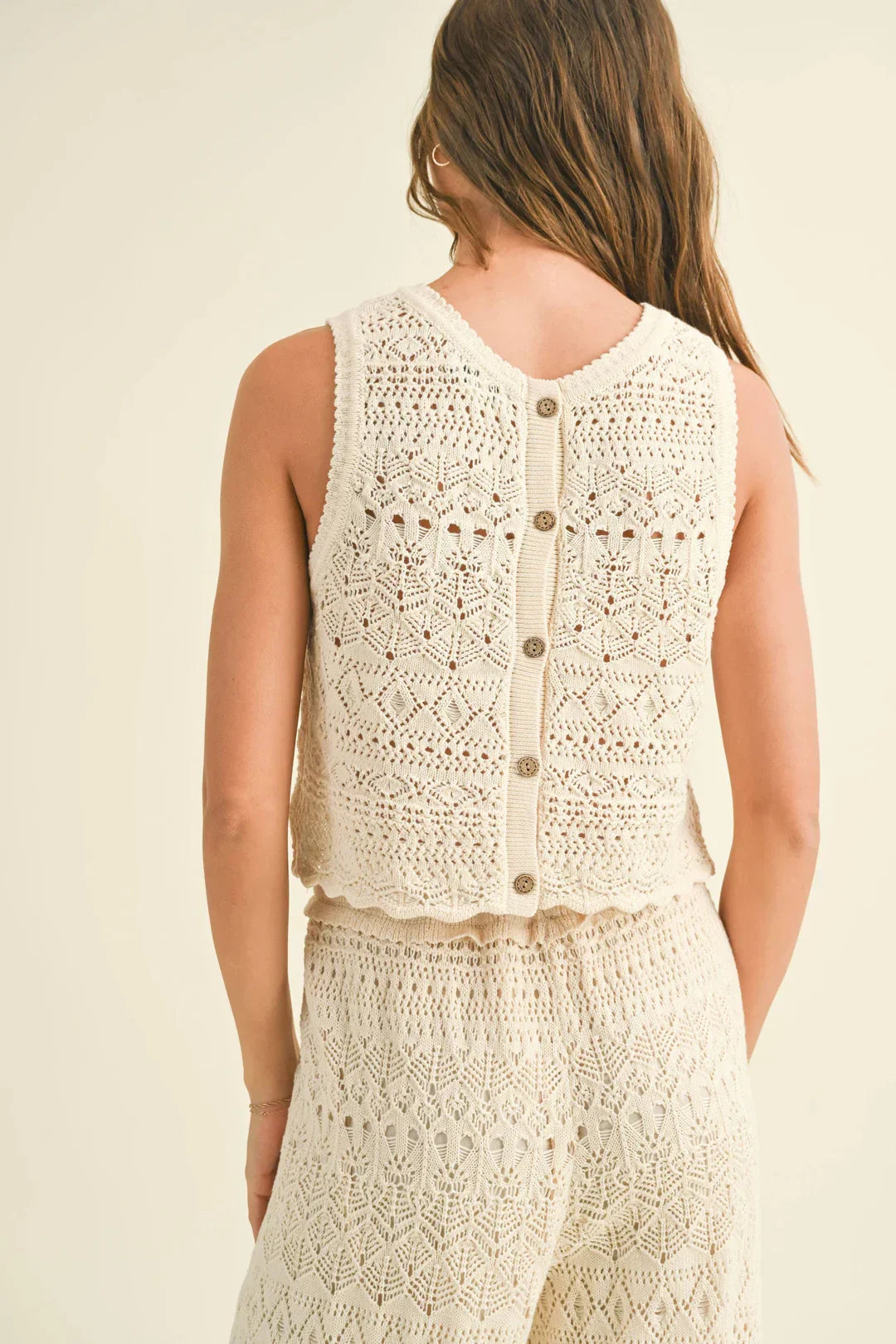 Crocheted white sleeveless top with button back for stylish match crochet pattern outfits