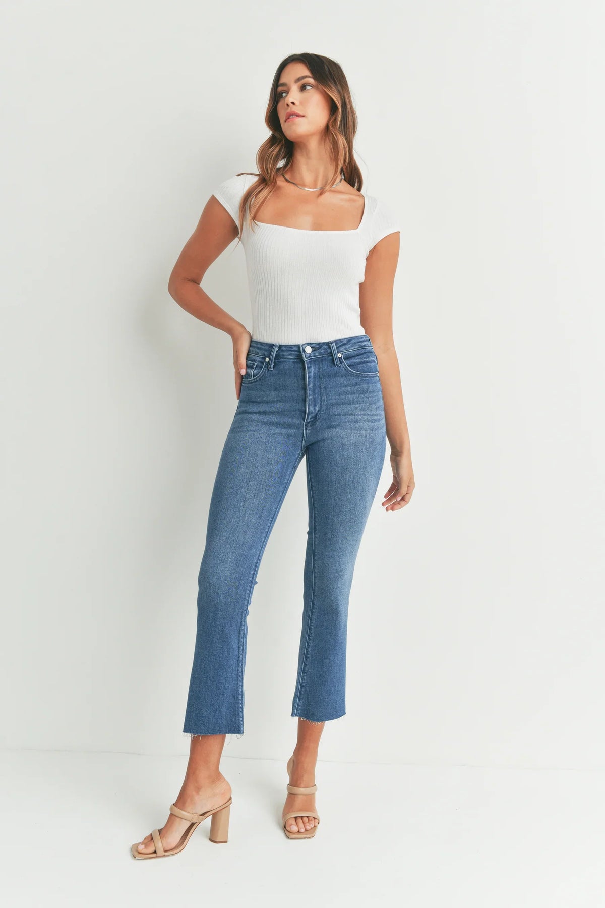 Cropped flare denim with a raw hem in medium wash, designed as slim fit flare denim jeans