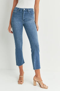 Cropped flare denim jeans with raw hem in medium blue wash for a slim fit style