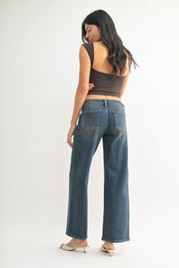 Dark brown sleeveless crop top with distressed blue low rise straight denim jeans
