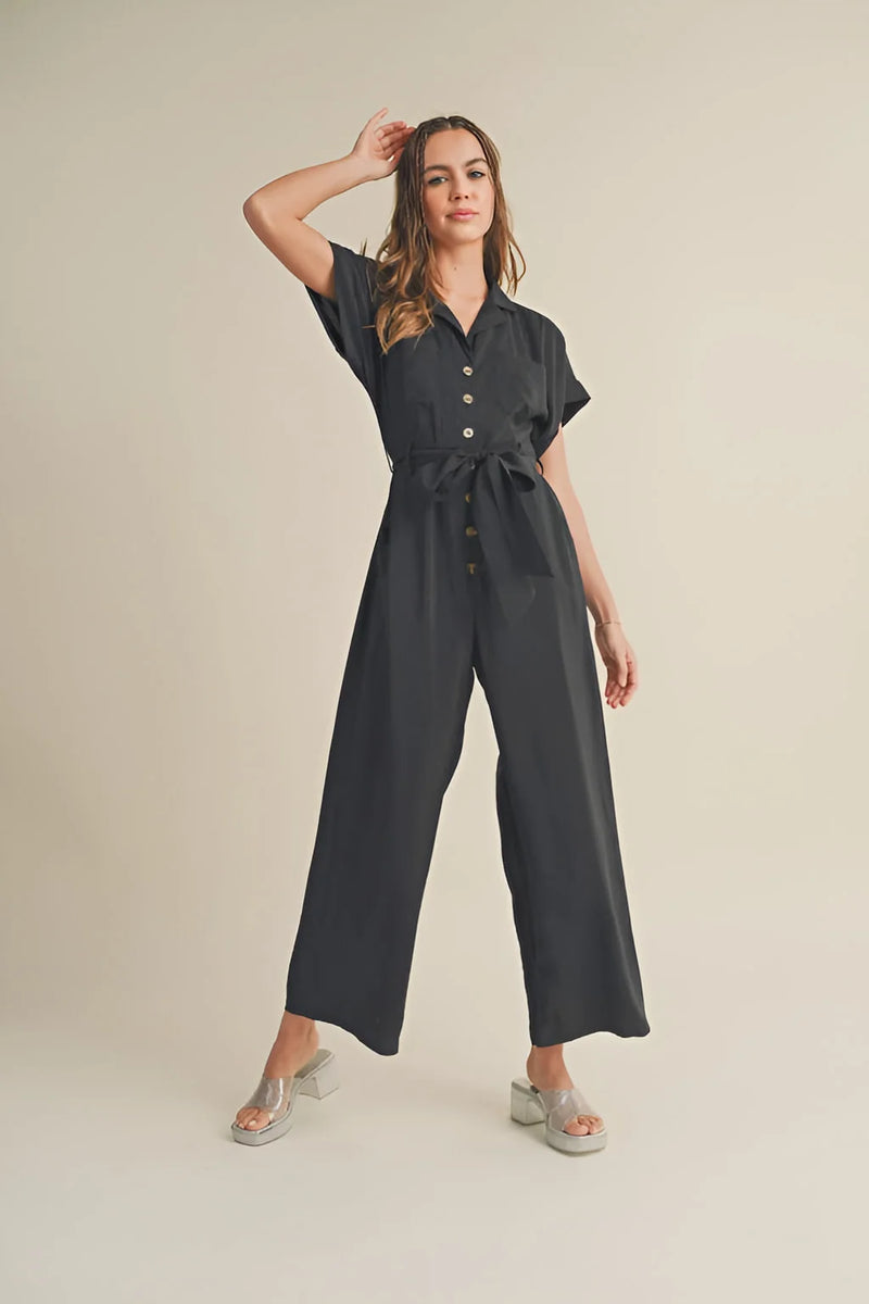 Dark-colored short sleeve buttonfront jumpsuit with flowy wide-leg pants