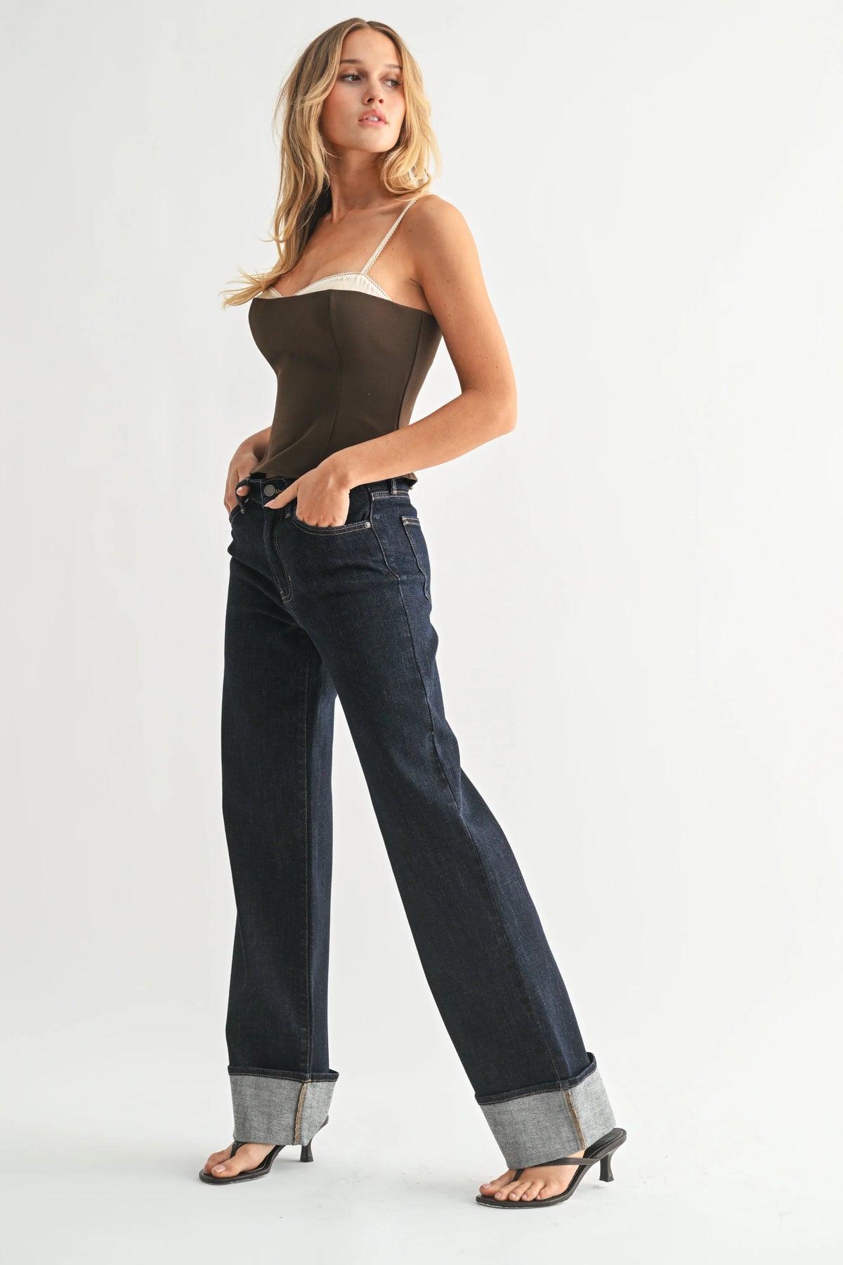 High rise cuffed wide leg jean in dark denim with rolled cuffs and heels