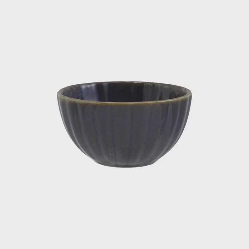 Dark gray stoneware ribbed bowl with fluted exterior and olive green rim