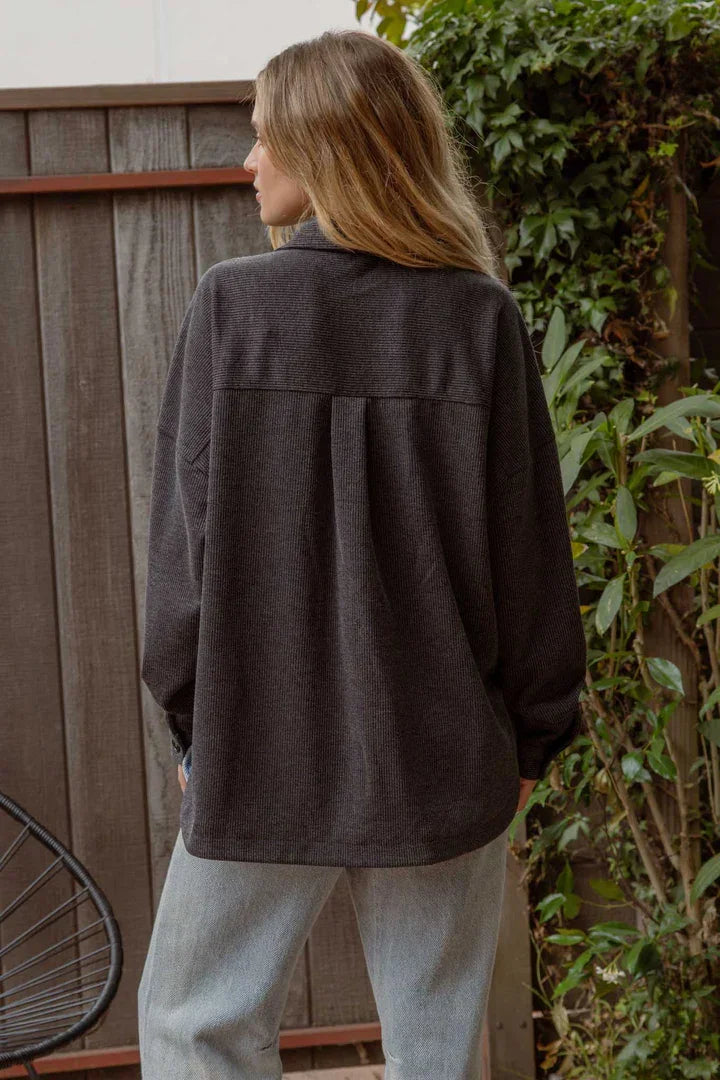 Dark gray oversized pinstripe button down shacket worn by a person with long blonde hair