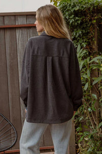 Dark gray oversized pinstripe button down shacket worn by a person with long blonde hair