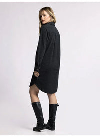 Dark gray turtleneck sweater dress with knee-high black boots, featuring a plush collared button