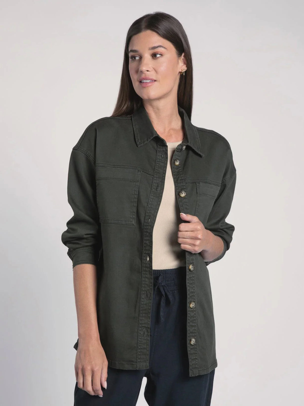 Dark green button-up overshirt worn by a woman with Denim Berkley Jacket style