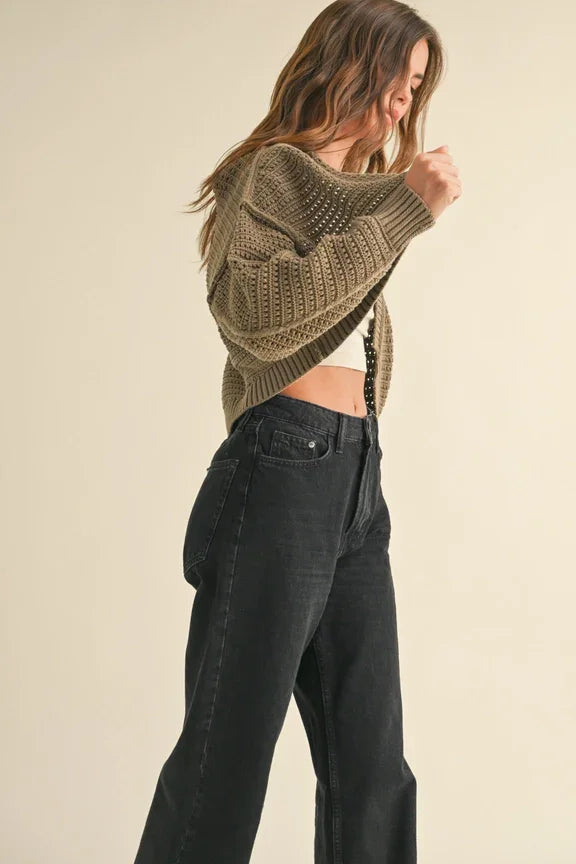 Dark straight-leg jeans with a cropped beige knit sweater, perfect for women’s boho chic clothing