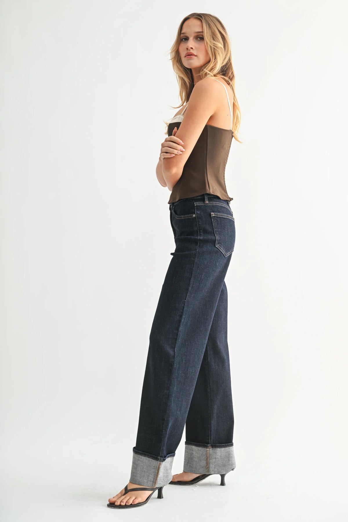 High rise cuffed wide leg jean in dark wash with rolled cuffs and black heels
