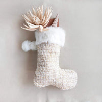 Decorative Christmas stocking featuring faux fur trim and floral accents in pink and white textiles