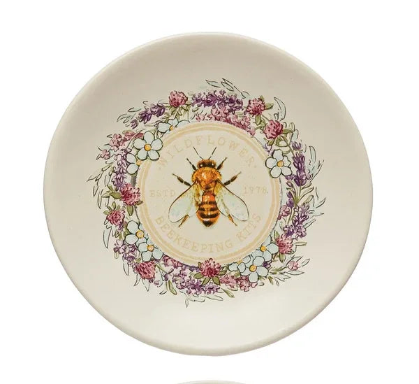 Decorative stoneware plate with bee illustration and floral wreath, perfect for boho decor