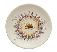 Decorative stoneware plate showcasing a honeybee illustration amid floral designs