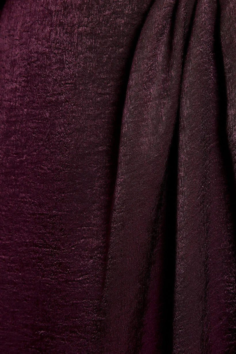 Deep burgundy velvet fabric draping on LONG SLEEVE SURPLICE MIDI DRESS for formal dinner dress