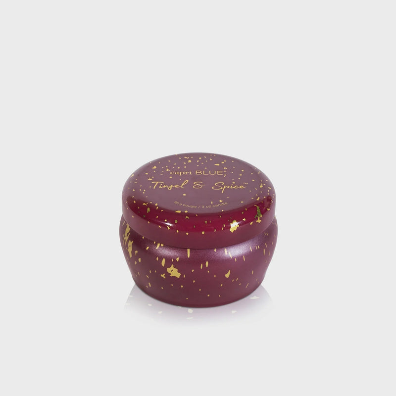 Deep red Tinsel & Spice Glimmer Mini Tin Candle with gold flecks in a round lidded mini tin