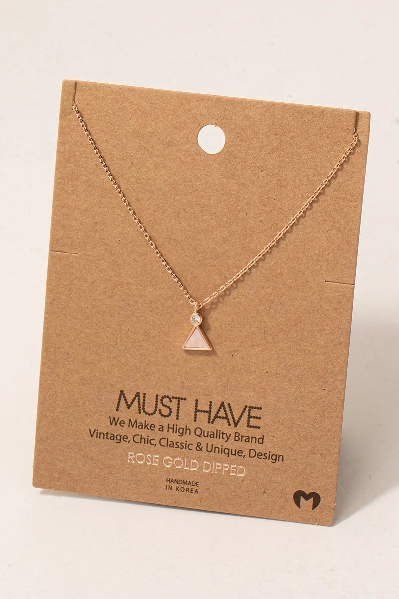 Delicate gold triangle pendant necklace with gemstone triangle pendant on jewelry card