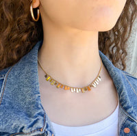 Water resistant tiny curb necklace with delicate gold chain and multicolored metallic charms