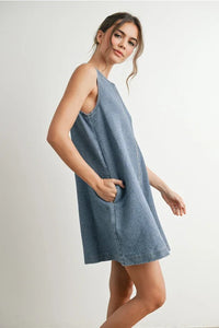Denim mini dress with sleeveless swing design and pockets, ideal for casual wear
