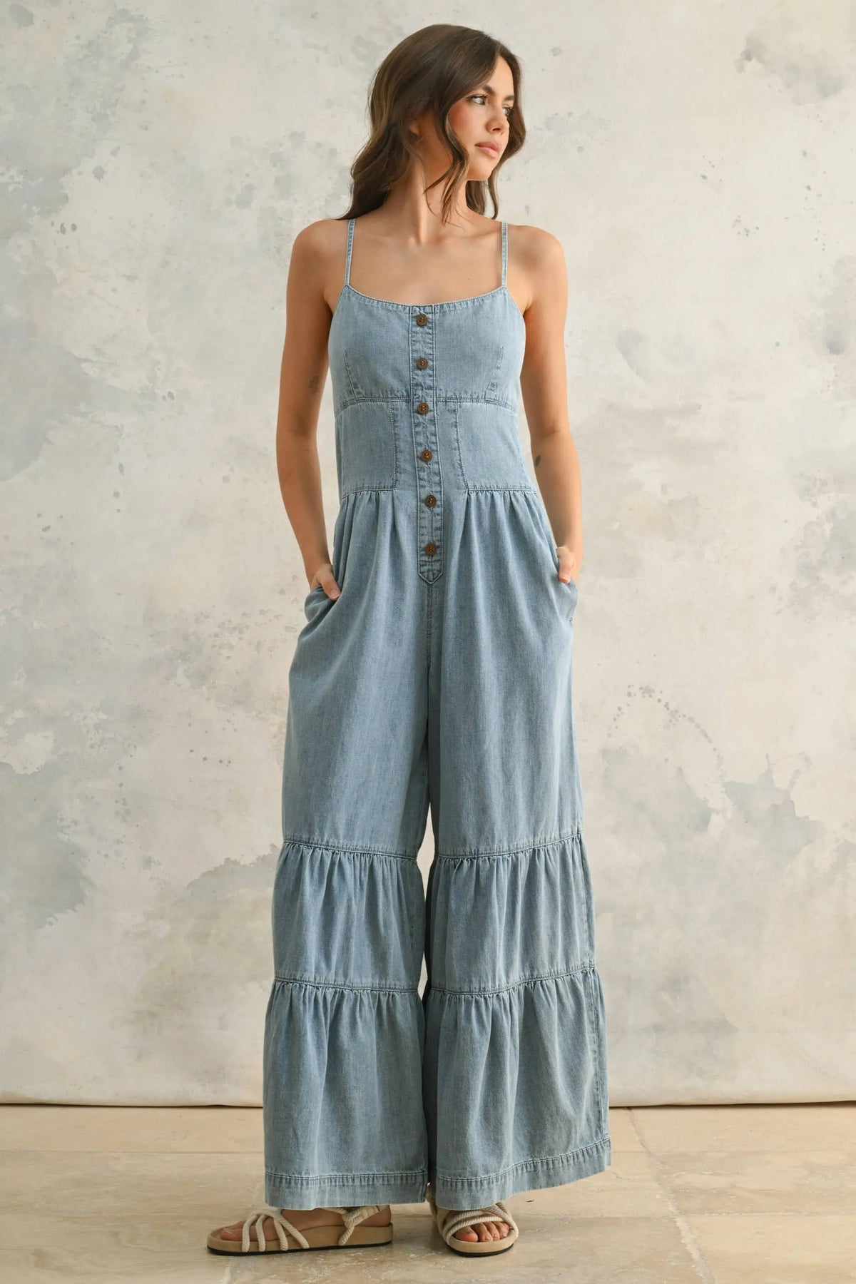 Chambray denim jumpsuit with button-front and tiered bottom detail