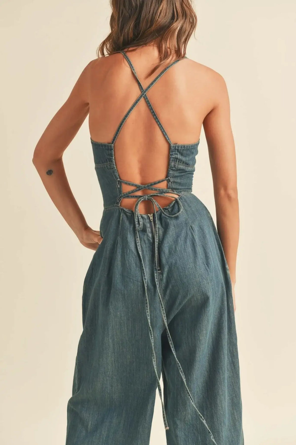 Denim jumpsuit with crisscross back in washed denim for a stylish look