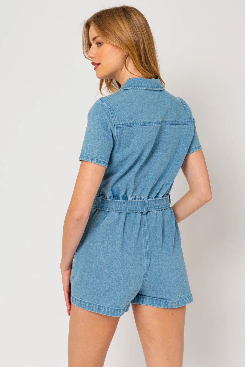 Woman in a short sleeve denim romper with cinched waist, showcasing boho style