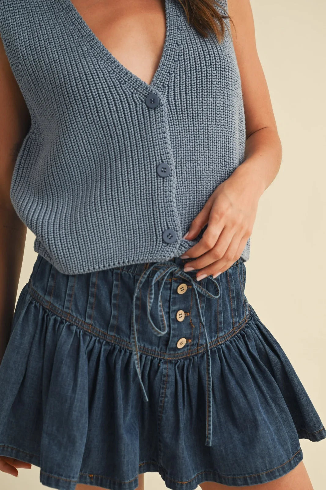 Denim ruffled mini skirt in sleeveless vest sweater style with buttons and pockets