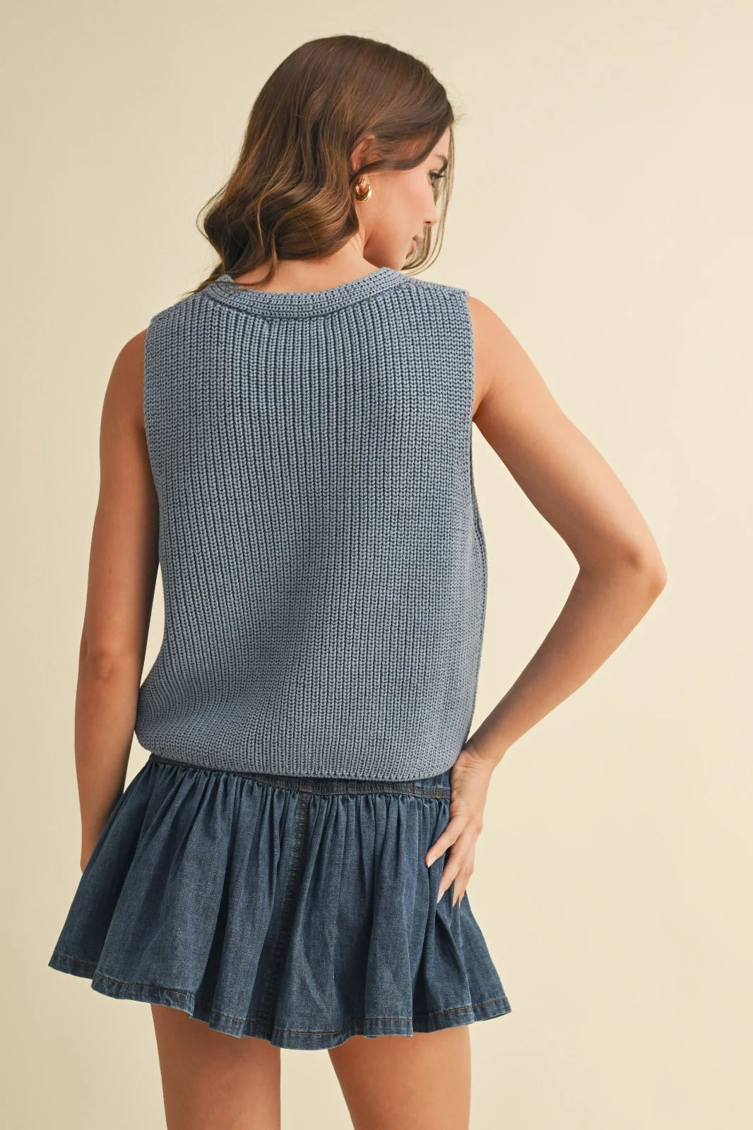 Distressed denim ruffled mini skirt with sleeveless vest sweater