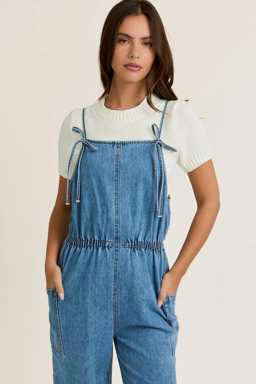 Denim overalls with bow ties and white knit sweater for women’s boho chic clothing