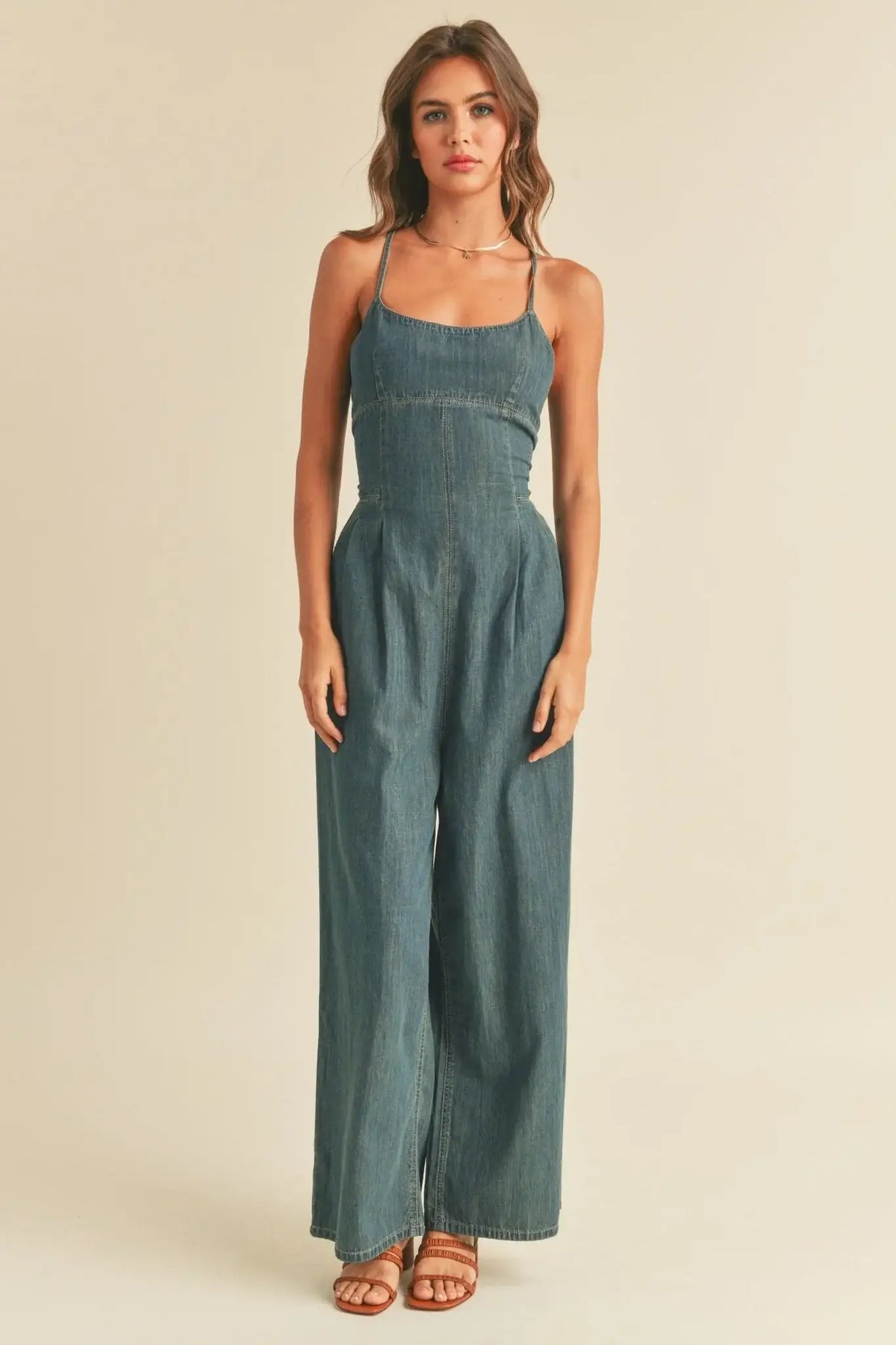Image of CALI TIE-BACK WASHED DENIM JUMPSUIT featuring a wide-leg washed denim jumpsuit style