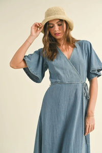 WASHED DENIM WRAP MAXI DRESS styled with a straw hat for a chic look