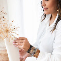 Dried Allium flower in a white vase enhancing the STONE WRAP BRACELET NECKLACE for women