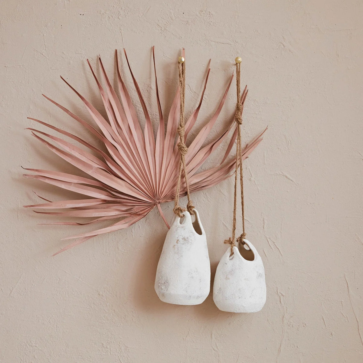 Dried pink palm leaf with white vases in a Hanging Coarse Stoneware Planter with Jute Rope Hanger