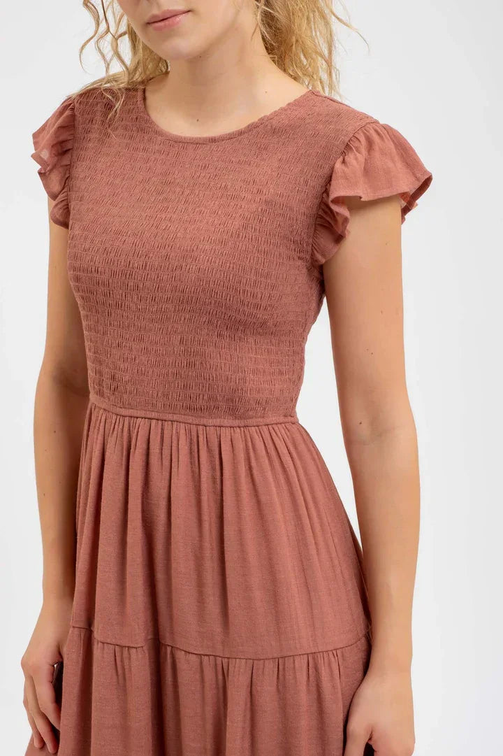 Dusty rose-colored smocked tiered midi dress with ruffled cap sleeves and gathered skirt