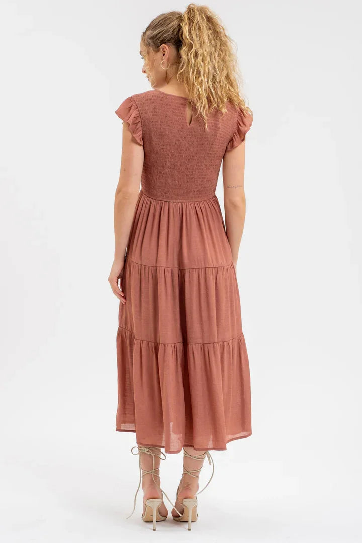 Dusty rose smocked tiered midi dress with short flutter sleeves and gathered waist