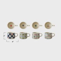 Eight colorful hand-painted stoneware mugs with floral, checkered, and cherry patterns