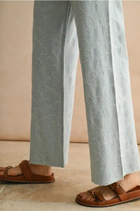 Embroidered light blue denim pants with floral stitch pattern from women’s boho chic clothing