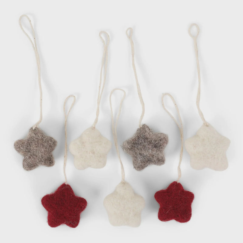 Handmade star ornaments with natural fiber texture in red and cream colors