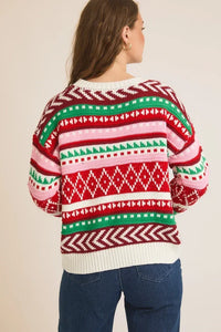 Round neck long sleeve colored Christmas sweater with geometric patterns and blue jeans