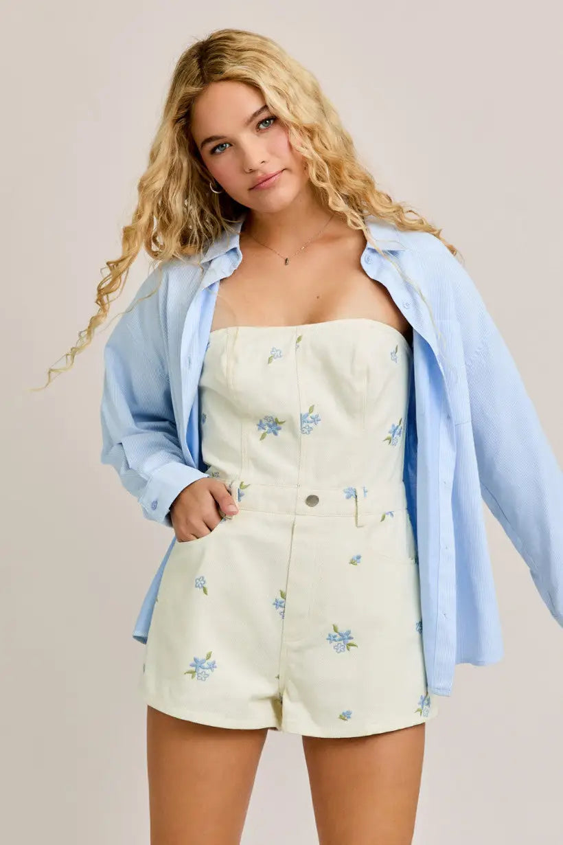 Floral embroidered strapless romper paired with light blue shirt from Shop Daisy’s women’s boho chic clothing