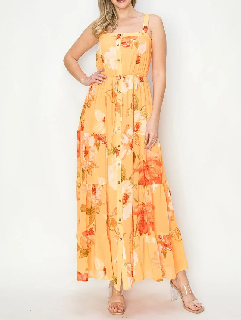 Floral print maxi dress in yellow and orange shades with thin straps, perfect for boho style