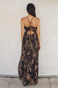 Floral maxi dress with criss-cross back straps and flowing pleated skirt design