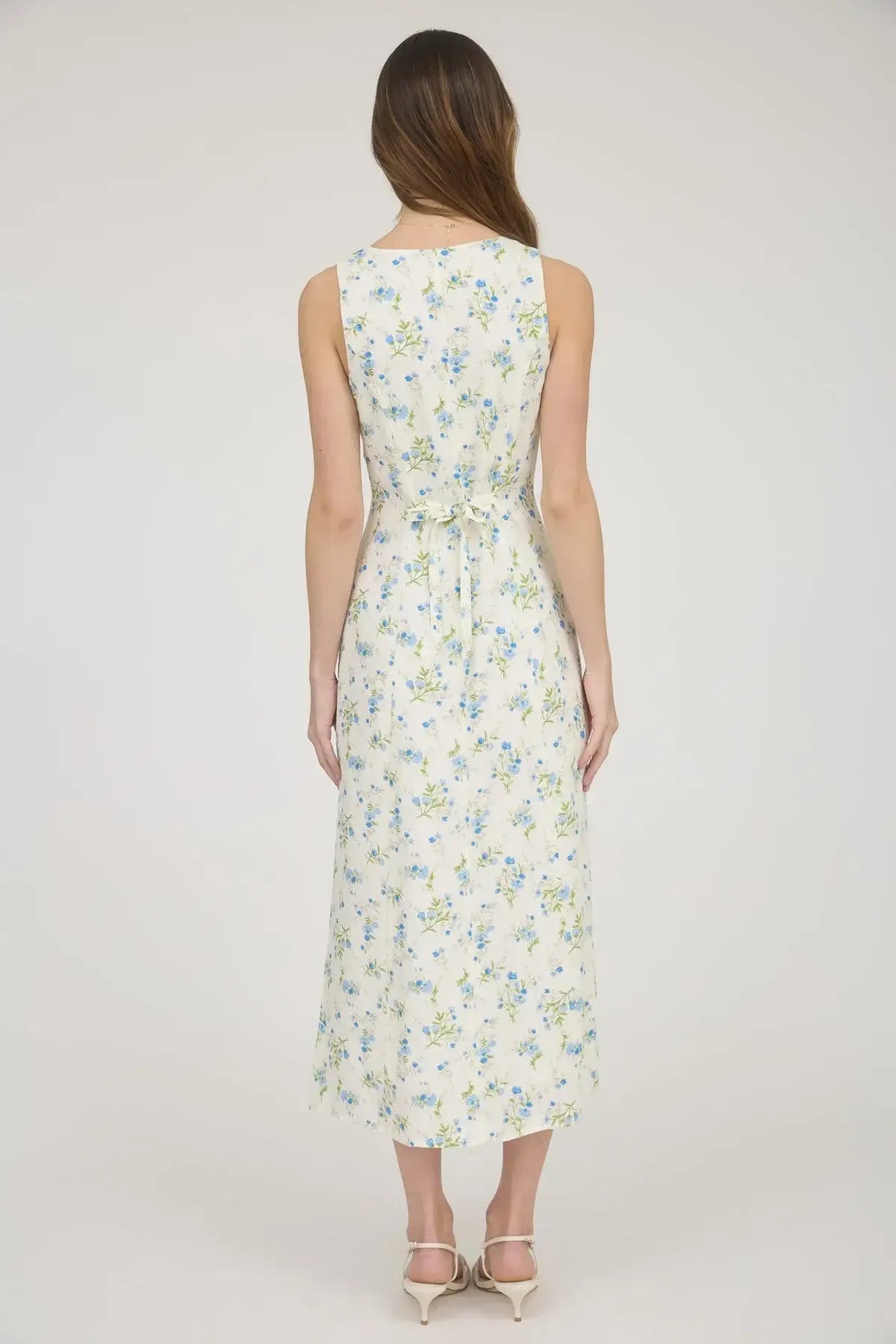 Floral sleeveless button down midi dress showcased in elegant fashion display