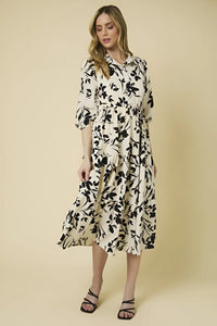 Elegant button down tiered floral print dress with three-quarter sleeves and a flowy silhouette