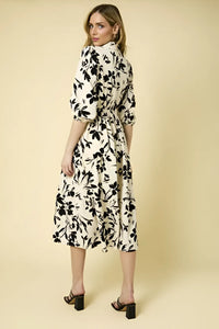 Floral print dress featuring a belted waist and three-quarter sleeves, tiered floral design