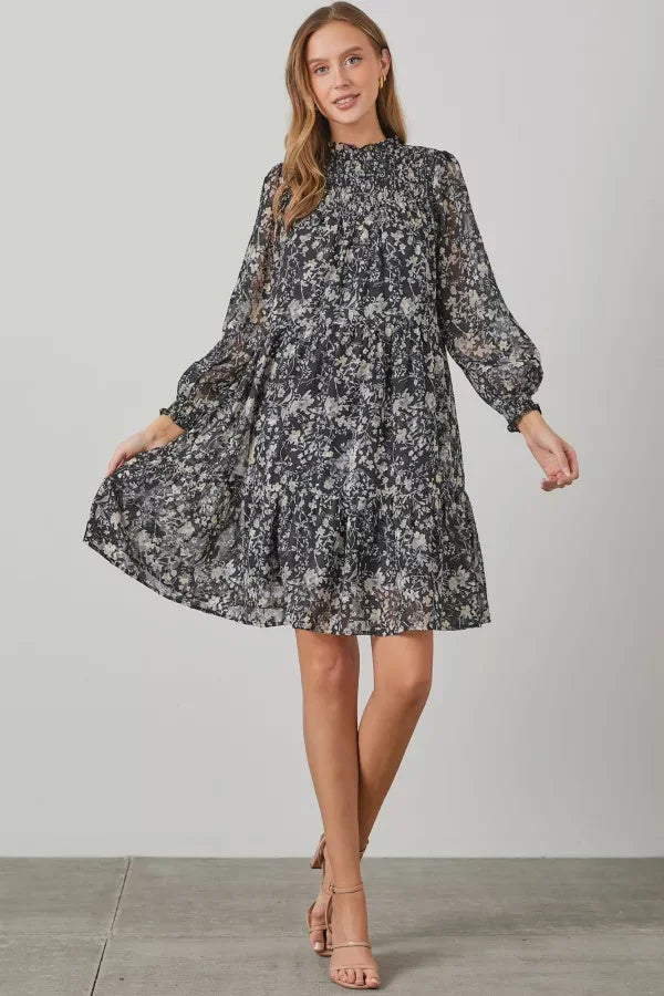 Floral print smocked yoke tiered dress with long sleeves and a high neckline