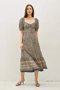 Elegant midi dress with paisley border print and puff sleeves, perfect for stylish occasions