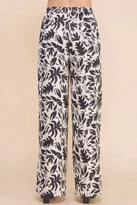 Flowy printed satin high waisted wide leg pants with black and white leaf print pattern