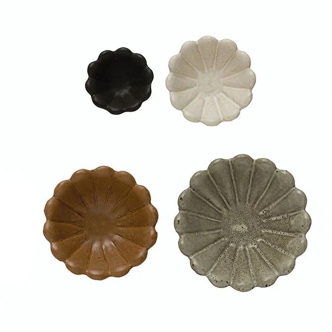 Four stoneware flower bowls in black, white, brown, and gray with reactive glaze finish