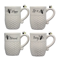 Ceramic white bee mugs featuring honeycomb textures and uplifting words displayed elegantly