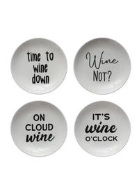 Four white stoneware dishes with wine sayings, perfect for women’s boho chic clothing displays at Shop Daisy