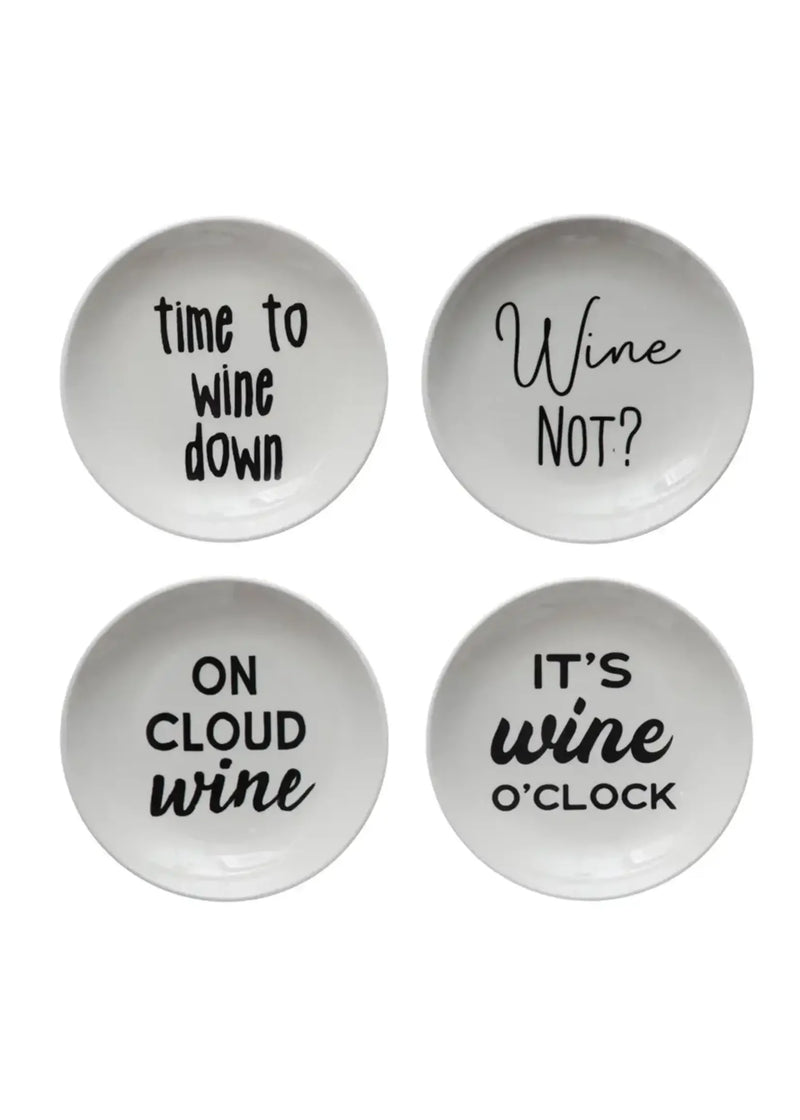 Four white stoneware dishes with wine sayings, perfect for women’s boho chic clothing displays at Shop Daisy